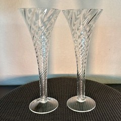 Two 9″ x 3.5″ hand blown, hollow stem, spiral champaign flutes. Very nice.