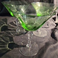 Set of three Fostoria uranium glass twisted stem coupes with clear faceted bowls