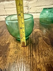 Set of four green glass roly poly style small bowls.