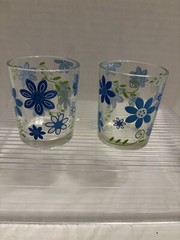 Two small clear glasses w/ blue flowers