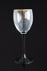 Contemporary wine glass with black stem , gold rim