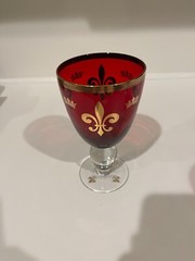 Two Ruby Red Wine Goblets with Gold Rims and Crown Insignias