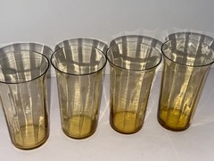 Set of 9 vintage amber glass tumblers with a flared rim.