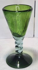 Hand-blown green glass goblet with a clear twisted stem and air bubbles