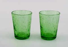 Biot, France. Two decanters, six glasses and two small jugs in green art glass.