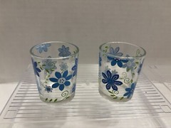 Two small clear glasses w/ blue flowers