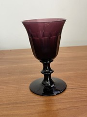 Faceted amethyst glass goblet with a decorative stem