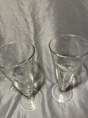 Footed pilsner glasses featuring an etched American eagle and stars design.
