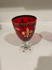 Two Ruby Red Wine Goblets with Gold Rims and Crown Insignias