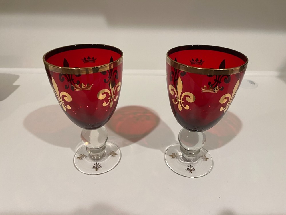 Two Ruby Red Wine Goblets with Gold Rims and Crown Insignias