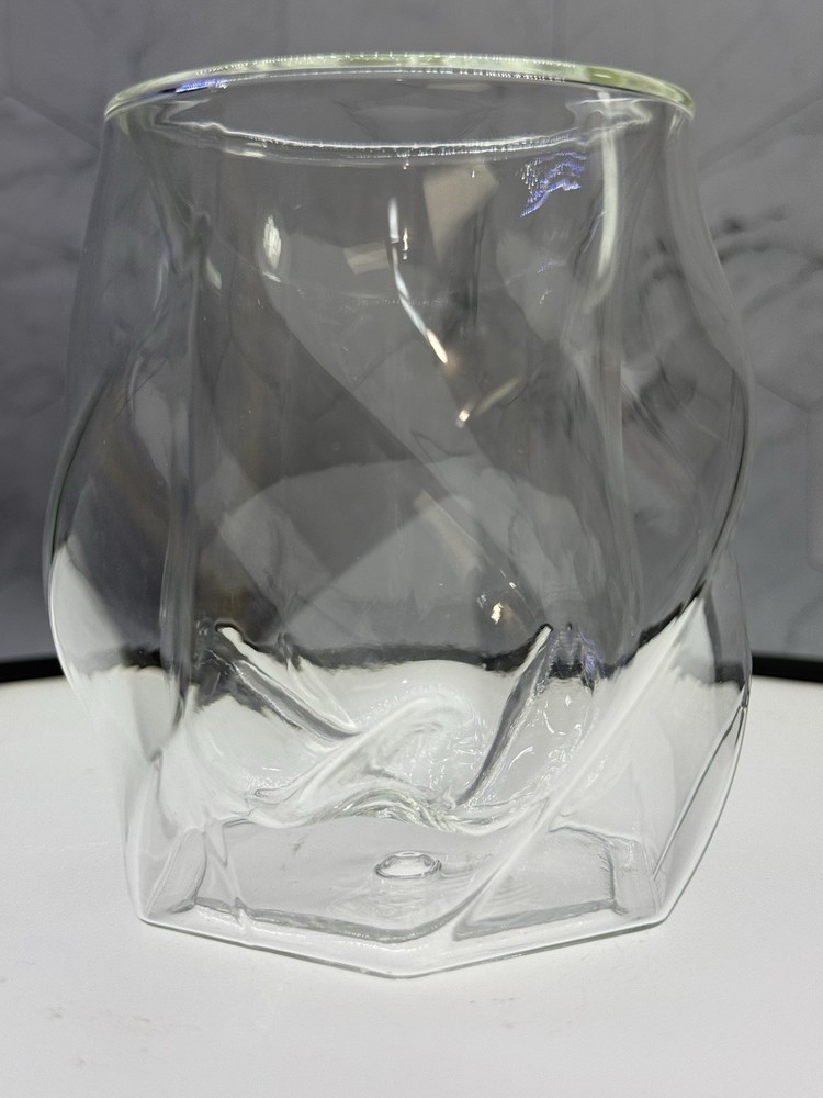 (1) double-walled glass tumbler features a unique twisted, ergonomic design