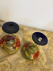 A pair of hand-painted glass margarita glasses with floral and leaf motifs.