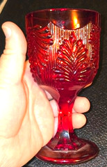 Vintage ruby red glass by L.G. Wright with textured botanical or swirled pattern