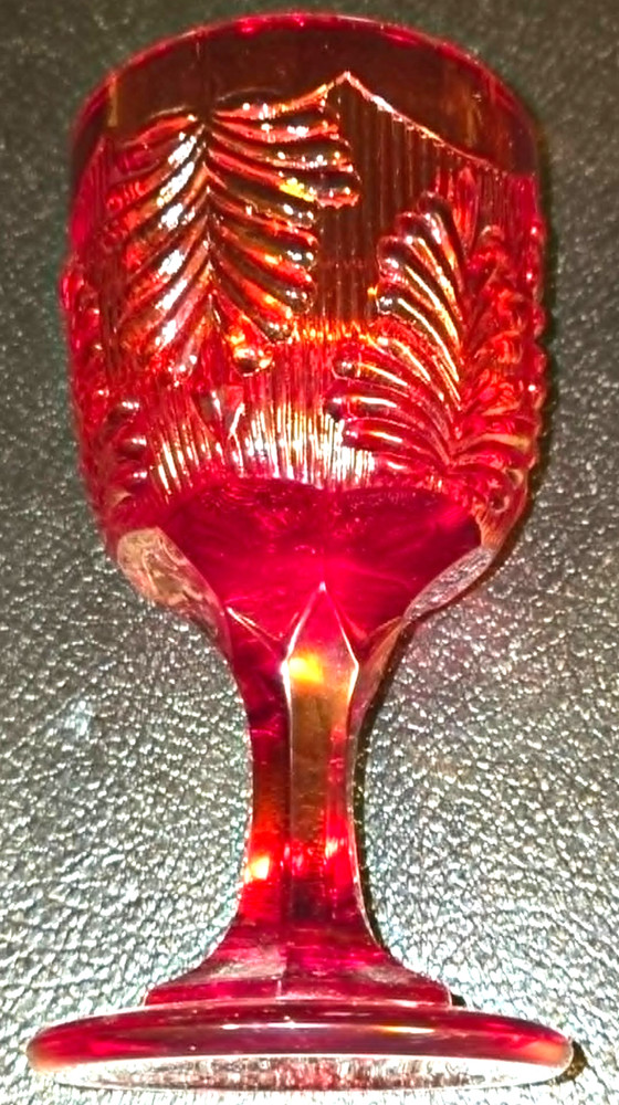 Vintage ruby red glass by L.G. Wright with textured botanical or swirled pattern