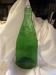 bottle flattened green glass 13″ tall 4.5 wide .020″ thick weighs 16.5oz hanger