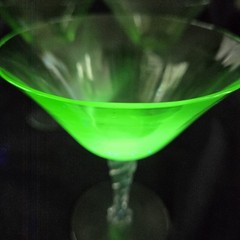 Set of three Fostoria uranium glass twisted stem coupes with clear faceted bowls