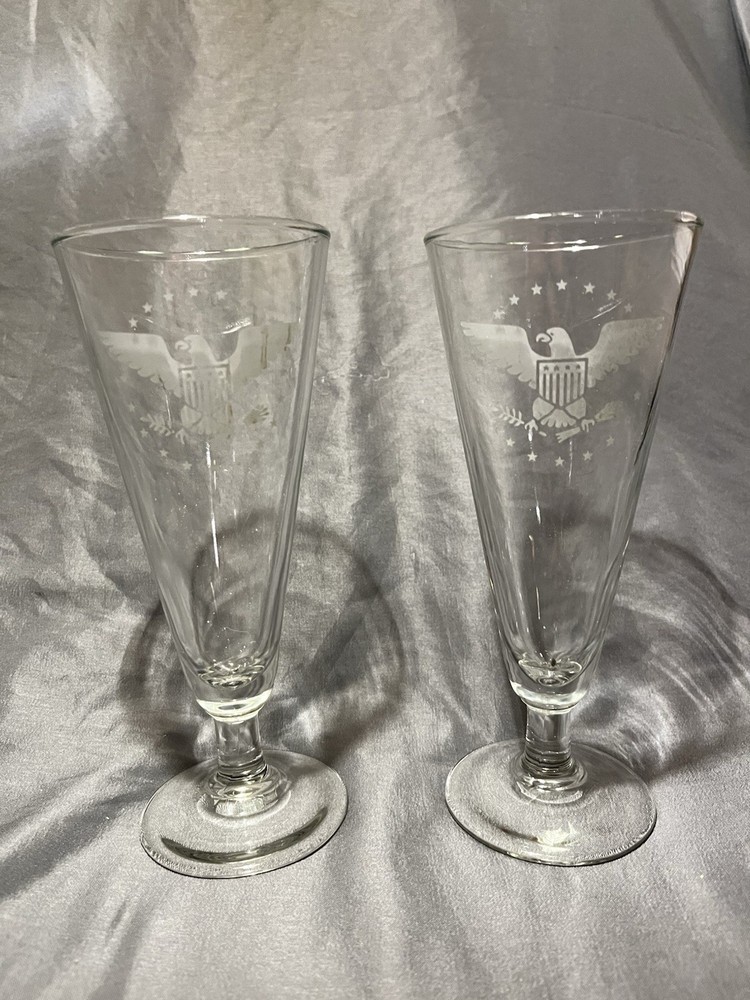 Footed pilsner glasses featuring an etched American eagle and stars design.
