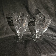 A pair of UV Reactive glass stemmed glasses with cut decoration.