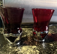 Vintage glass tumblers set in chrome-plated holders.