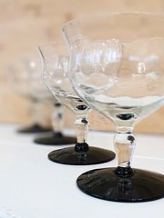 Vintage Weston glass black foot champagne glasses featuring wavy optic bowl.