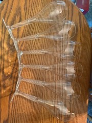 Beautiful set of six clear champagne flutes with distinctively long, delicate, a