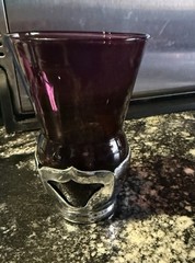 Vintage glass tumblers set in chrome-plated holders.