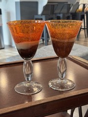 Handblown art glass stemmed goblets with orange, beige, and brown coloration