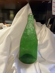 bottle flattened green glass 13″ tall 4.5 wide .020″ thick weighs 16.5oz hanger