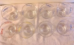 8 VINTAGE UNUSED LO-BALL GLASSES. BLUE, RED, YELLOW, WHITE. 3.25 INCHES TALL.