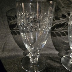 A pair of UV Reactive glass stemmed glasses with cut decoration.