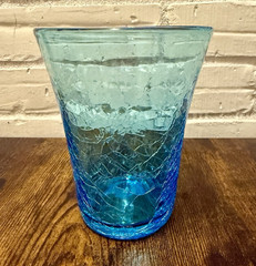 A vintage hand-blown blue crackle glass tumbler/vase.