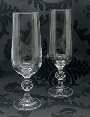 Set of 2 ‘Claudia’ by IMPORT ASSOC Crystal fluted champagne stems. 6 3/4″