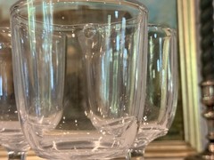 A set of five clear glass vintage cordial or small wine glasses.
